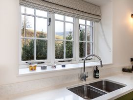A kitchen with a window above the sink at The Old Bunkhouse in Grasmere