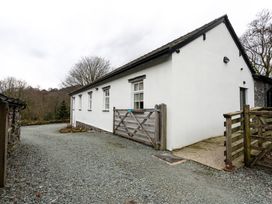 A house with a gravel driveway and gate at The Old Bunkhouse in Grasmere