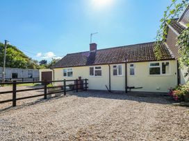An outdoor view of a house with gravel area at Court House Farmhouse in Charmouth