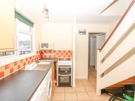 A kitchen with appliances and counters at Court House Farmhouse in Charmouth