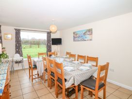 A dining room with a large table and chairs at Court House Farmhouse in Charmouth