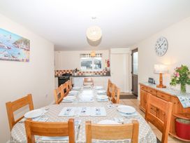 A dining room with a table set for dinner at Court House Farmhouse in Charmouth
