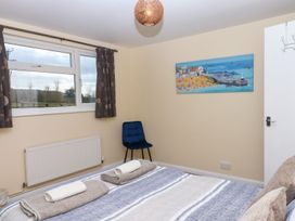 A bedroom with a bed and chair at Court House Farmhouse in Charmouth