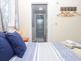 A bedroom with a bed and an adjoining bathroom at Court House Farmhouse in Charmouth