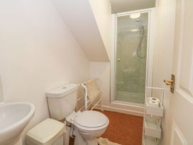 A bathroom with a toilet, sink, and shower at Court House Farmhouse, Charmouth