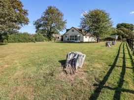 An outdoor view of a house and garden at Court House Farmhouse in Charmouth