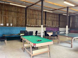 A recreation room with a pool table and dining area at Court House Farmhouse in Charmouth