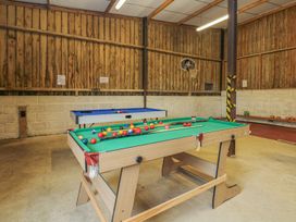 A games room with a pool table and snooker table at Court House Farmhouse in Charmouth