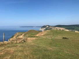 A view of hills and the ocean at Court House Farmhouse in Charmouth