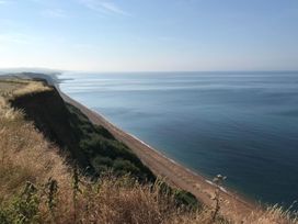A view of the beach and ocean from a cliff at Court House Farmhouse in Charmouth