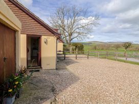 An exterior view of a house with gravel area and tree at Court House Farmhouse Charmouth