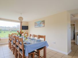 A dining room with a table set for dining at Court House Farmhouse in Charmouth