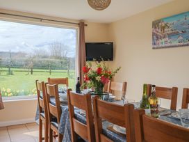 A dining room with a table set for dinner at Court House Farmhouse in Charmouth