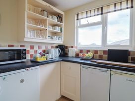 A kitchen with appliances and countertop at Court House Farmhouse in Charmouth