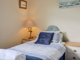 A bedroom with a bed and lamp at Court House Farmhouse in Charmouth
