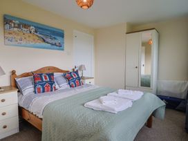 A bedroom with a bed and wardrobe at Court House Farmhouse in Charmouth