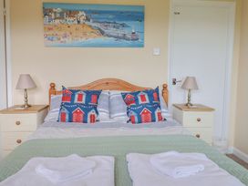 A bedroom with a bed and bedside table at Court House Farmhouse in Charmouth