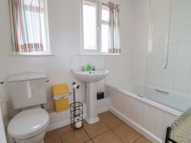 A bathroom with a sink and bathtub at Court House Farmhouse in Charmouth