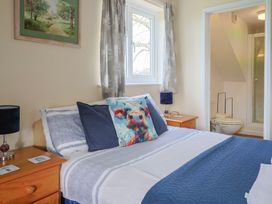A bedroom with a bed and adjoining bathroom at Court House Farmhouse in Charmouth