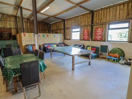 A recreation room with a table and chairs at Court House Farmhouse in Charmouth