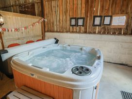 A hot tub in an indoor spa area at Court House Farmhouse in Charmouth