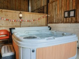 A hot tub in a wooden room at Court House Farmhouse in Charmouth