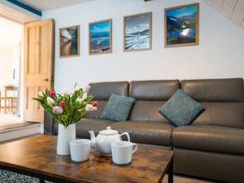 A living room with a sofa and a coffee table at Garn View in Dolgellau