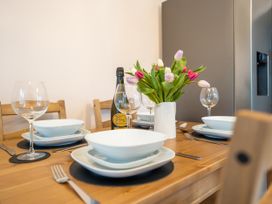 A dining table set with plates and glasses at Garn View in Dolgellau
