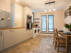 A kitchen with appliances and dining area at Garn View in Dolgellau