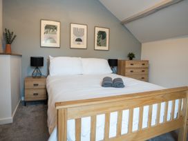 A bedroom with a bed and bedside table at Garn View in Dolgellau