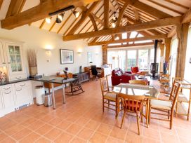 A living room with a table and chairs at Nature's Lodge in Cookley