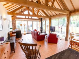 A living room with wooden beams and furniture at Nature's Lodge in Cookley