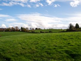 A field with grass and trees at Nature's Lodge Cookley