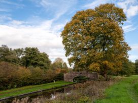 A tree beside a bridge over a canal at Nature's Lodge Cookley