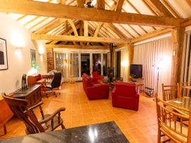 A living room with a sofa, chairs, and a fireplace at Nature's Lodge in Cookley