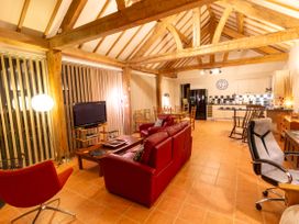 A living room with a sofa and television at Nature's Lodge in Cookley