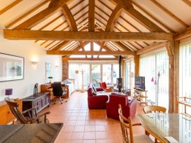 A living room with sofas and a television at Nature's Lodge in Cookley