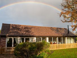 A house with a fence and garden at Nature's Lodge Cookley