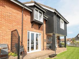 An outdoor area with a patio and furniture at Cotman Cottage Norwich