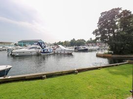 A marina with boats docked and grassy area at Cotman Cottage in Norwich