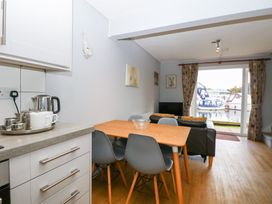 A dining room with a table and chairs at Cotman Cottage in Hoveton & Wroxham