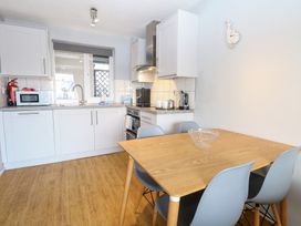 A kitchen with a table and chairs at Cotman Cottage in Hoveton & Wroxham