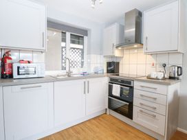 A kitchen with appliances and fixtures at Cotman Cottage Hoveton & Wroxham