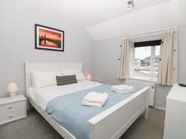 A bedroom with a bed and window at Cotman Cottage in Hoveton & Wroxham
