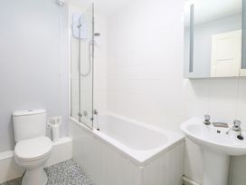 A bathroom featuring a toilet, bathtub, sink, and shower at Cotman Cottage in Hoveton & Wroxham