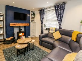 A living room with a fireplace and television at 6 Upperfield Street in Dolgellau