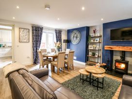A living room with a dining area and a fireplace at 6 Upperfield Street in Dolgellau