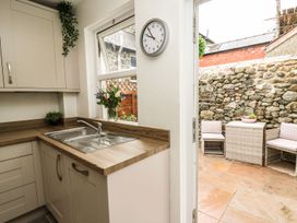 A kitchen with a sink and view to the outdoor seating area at 6 Upperfield Street Dolgellau