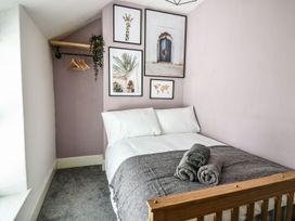 A bedroom with a bed and wall art at 6 Upperfield Street, Dolgellau