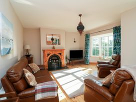 A living room with a fireplace and sofa at The Lodge Bolinahaney, Bunclody, County Wexford